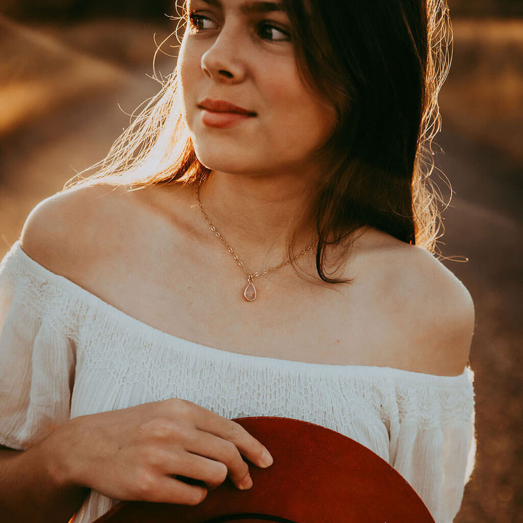 unity rose quartz teardrop gemstone pendant necklace worn on model by Peacock & Lime
