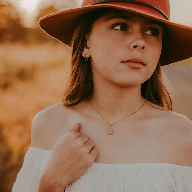 unity rose quartz teardrop gemstone pendant necklace worn on model by Peacock & Lime