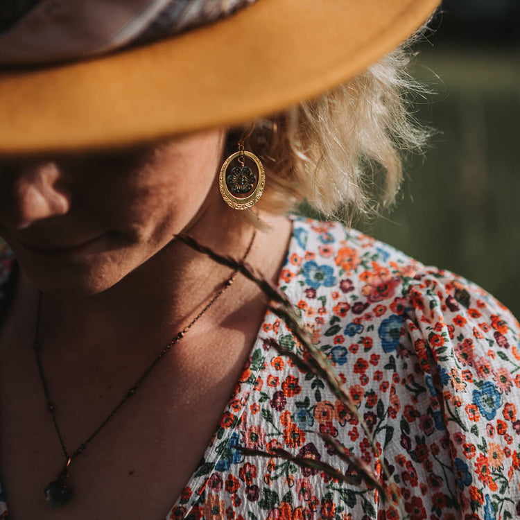 anemone // flower and embossed brass hoop earrings worn on model by Peacock and Lime