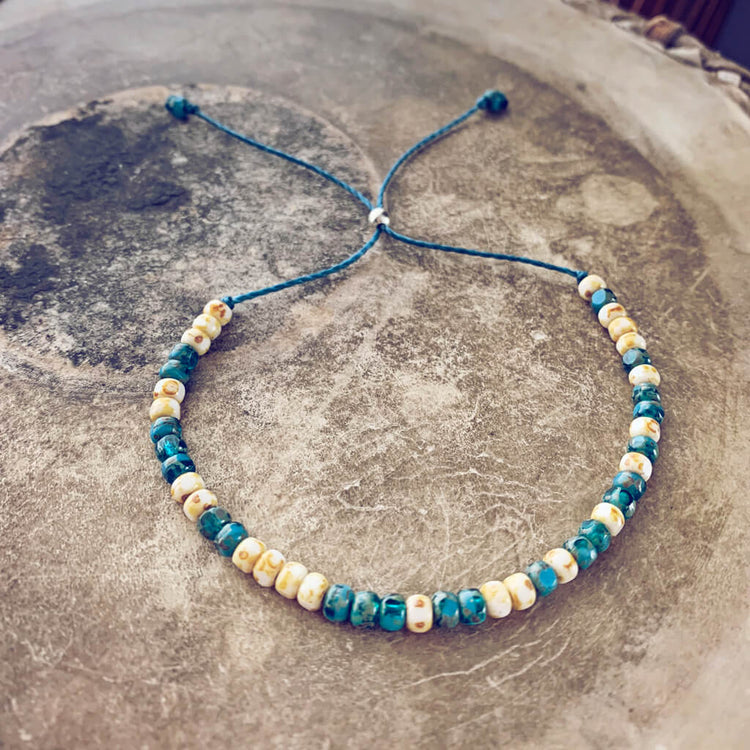 beach side // turquoise blue and white beaded cord bracelet by Peacock & Lime