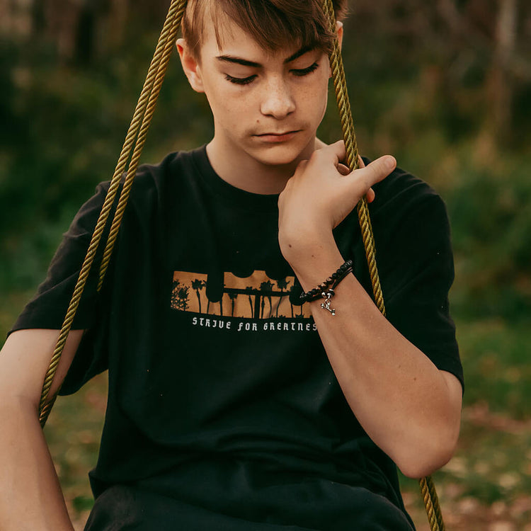 keep moving forward // unisex leather wrap bracelet with pewter arrow clasp - worn on model - Peacock & Lime