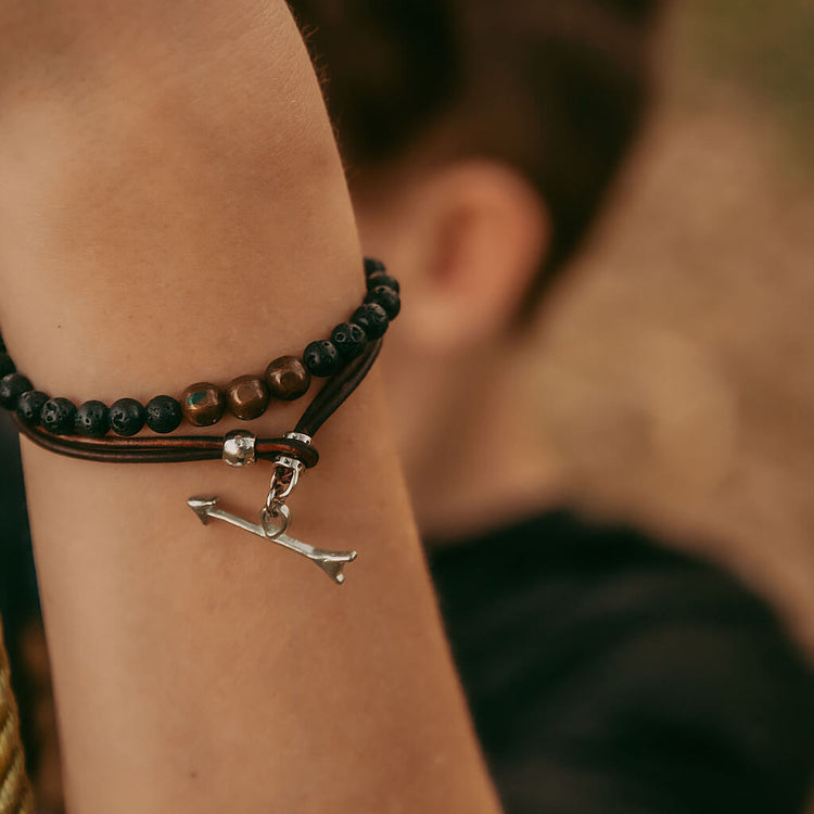 keep moving forward // unisex leather wrap bracelet with pewter arrow clasp - worn on model - Peacock & Lime