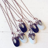 lux ex tenebris // copper electroformed opalite or black agate and crescent moon necklaces by Peacock and Lime