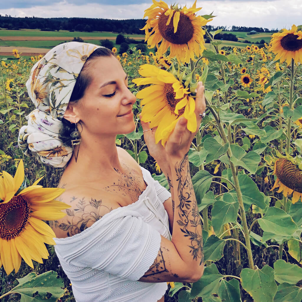 pulsar // boho antiqued brass sun star triangle & peridot earrings worn on model - Peacock & Lime