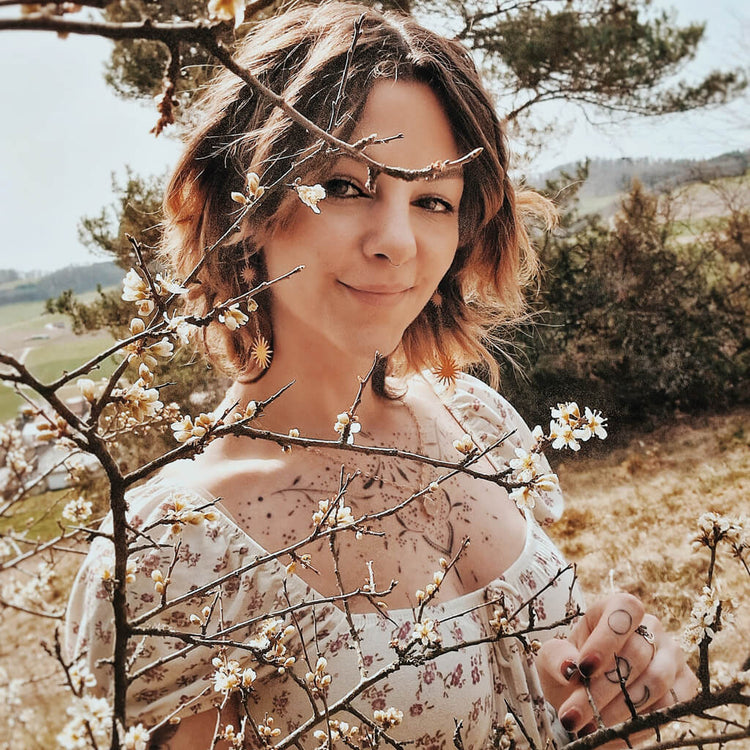 unity rose quartz teardrop gemstone pendant necklace and starburst post & chain dangle earrings worn on model by Peacock & Lime