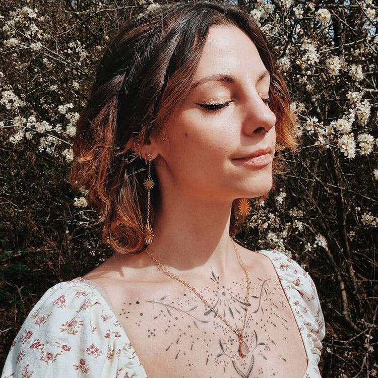 unity rose quartz teardrop gemstone pendant necklace and starburst post & chain dangle earrings worn on model by Peacock & Lime
