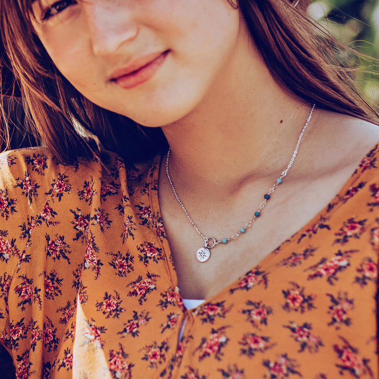 true north star compass necklace worn on model - Peacock & Lime