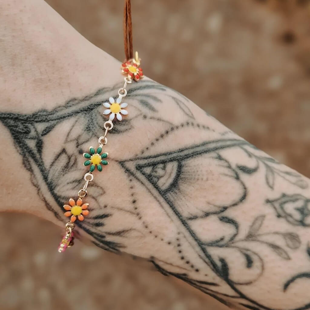 flower child // multi color enamel daisy flower chain and adjustable cord bracelet worn on model - by Peacock & Lime