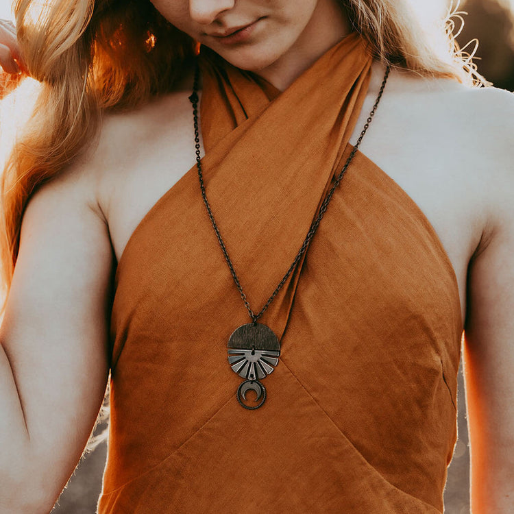 orbis // patina aged darkened sun, moon, sphere & crescent moon necklace worn on model - by Peacock & Lime