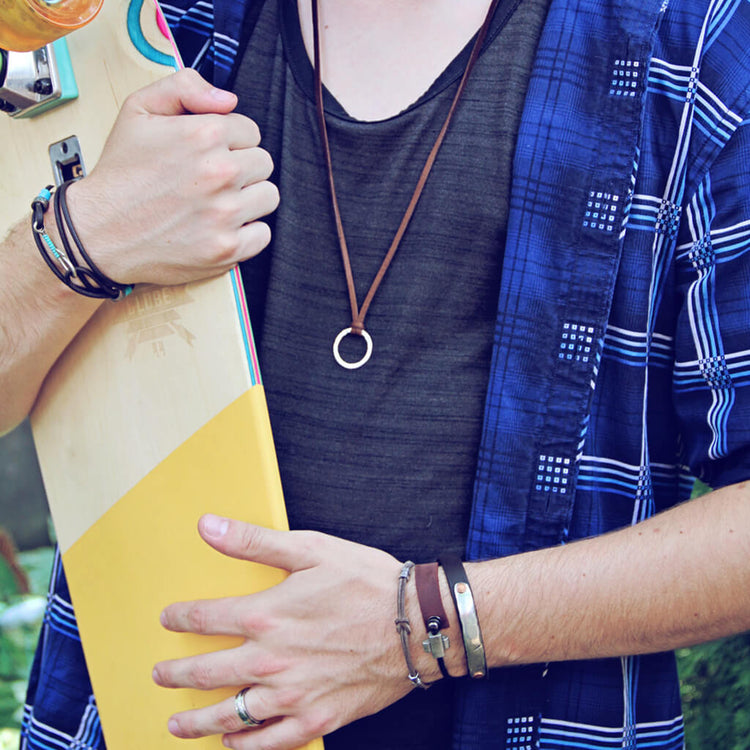 double hex // simple distressed grey brown leather knot bracelet with pewter hex beads shown on model with other bracelets by Peacock & Lime