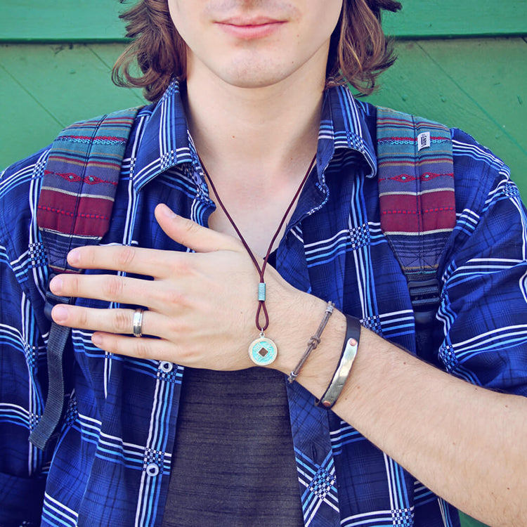 double hex // simple distressed grey brown leather knot bracelet with pewter hex beads shown on model with other bracelets by Peacock & Lime