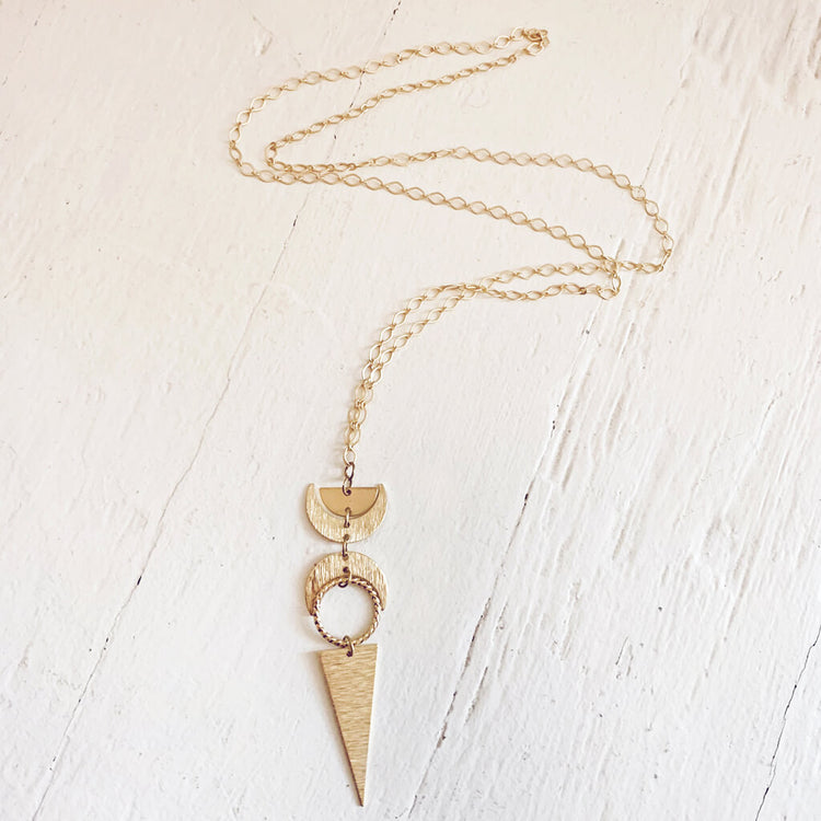 moon phases // half moon, waxing, waning crescent moons, new moon and long triangle pendant necklace by Peacock & Lime