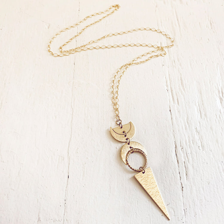 moon phases // half moon, waxing, waning crescent moons, new moon and long triangle pendant necklace by Peacock & Lime