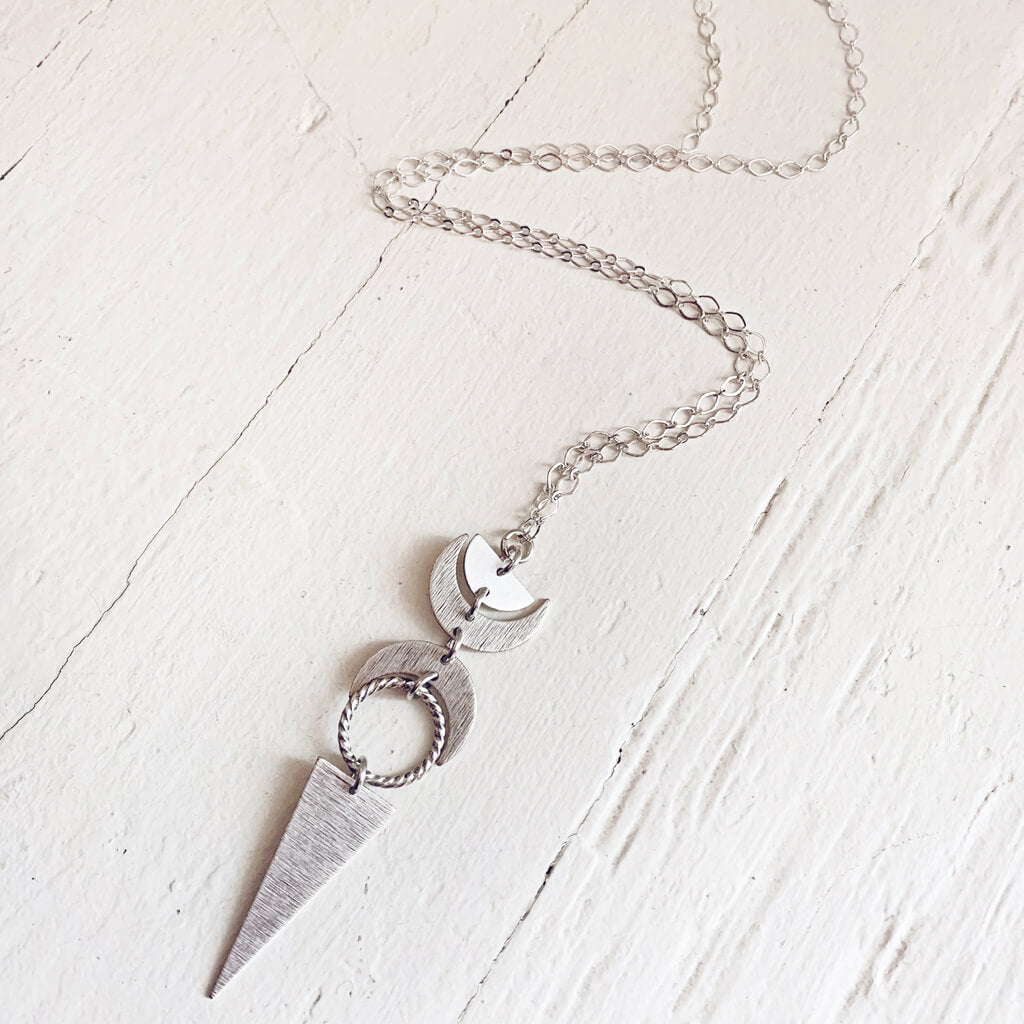 moon phases // half moon, waxing, waning crescent moons, new moon and long triangle pendant necklace by Peacock & Lime