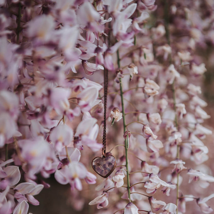 wild at heart // copper electroformed amethyst chip heart pendant necklace hanging amongst the flowers by Peacock & Lime